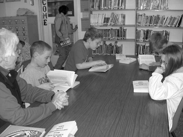 Children at Monroe Elementary School peruse the dictionaries made available through the efforts of the Philomath Rotary Club